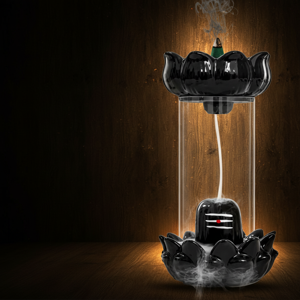 Close-up of a "Shiva Smoke Fountain" backflow incense burner with a lotus design, showing white smoke flowing like a waterfal
